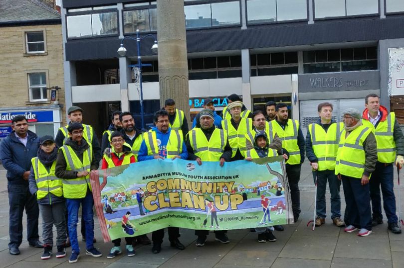 Young Muslims tidy up the streets of Huddersfield on New Years Day